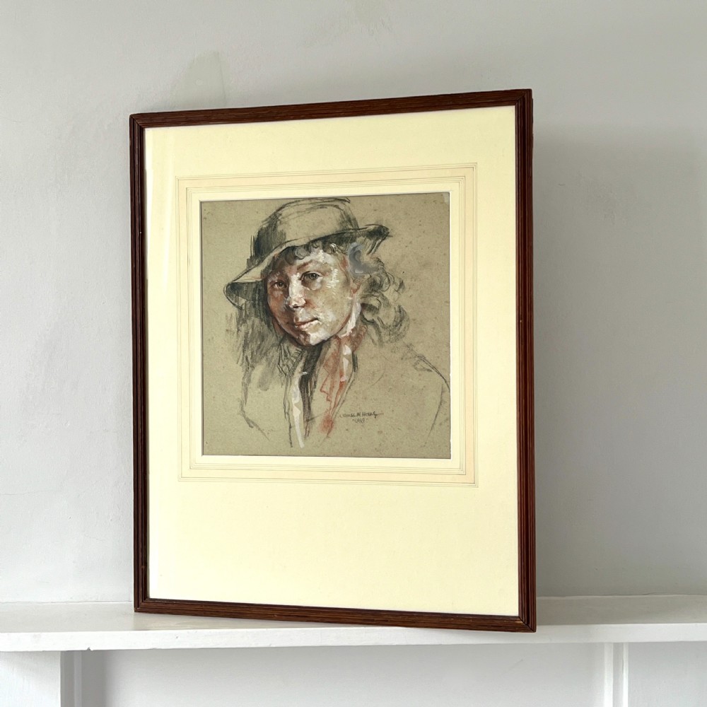 A framed original pastel drawing on grey paper depicting a figure in a hat, dated 1939, presented in a dark wood frame. View IV
