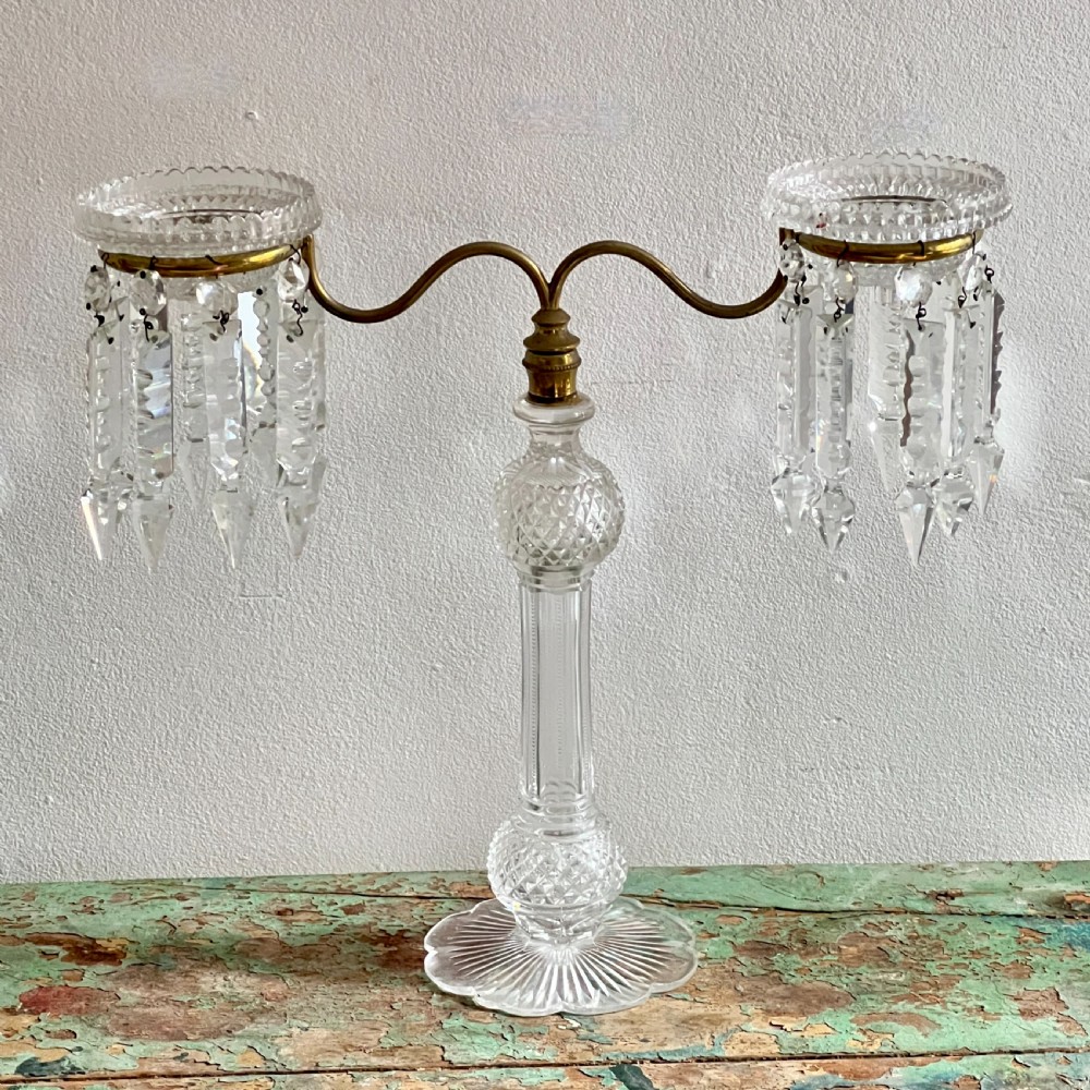 A pair of late Victorian two-light cut glass and brass Cricklite candelabra featuring suspended crystal prisms and clear glass pedestals. View V