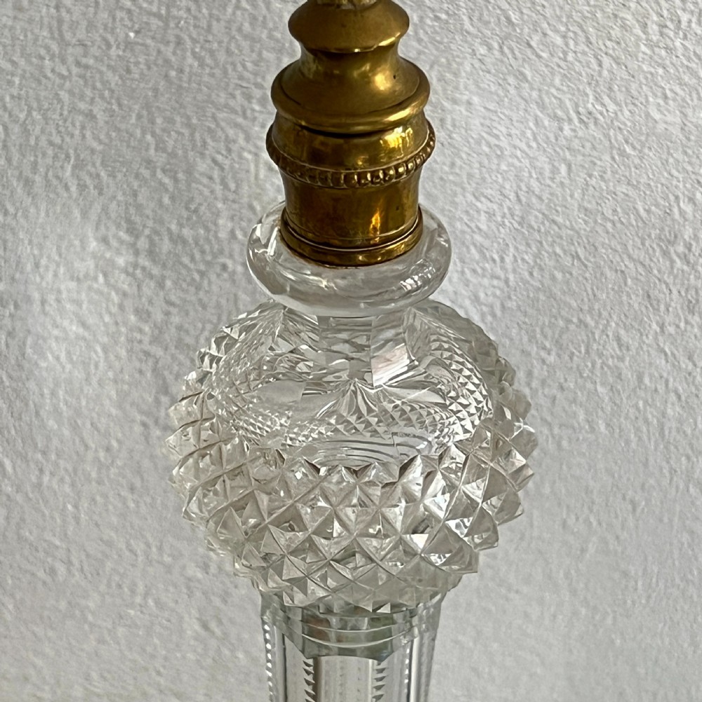 A pair of late Victorian two-light cut glass and brass Cricklite candelabra featuring suspended crystal prisms and clear glass pedestals. View VI