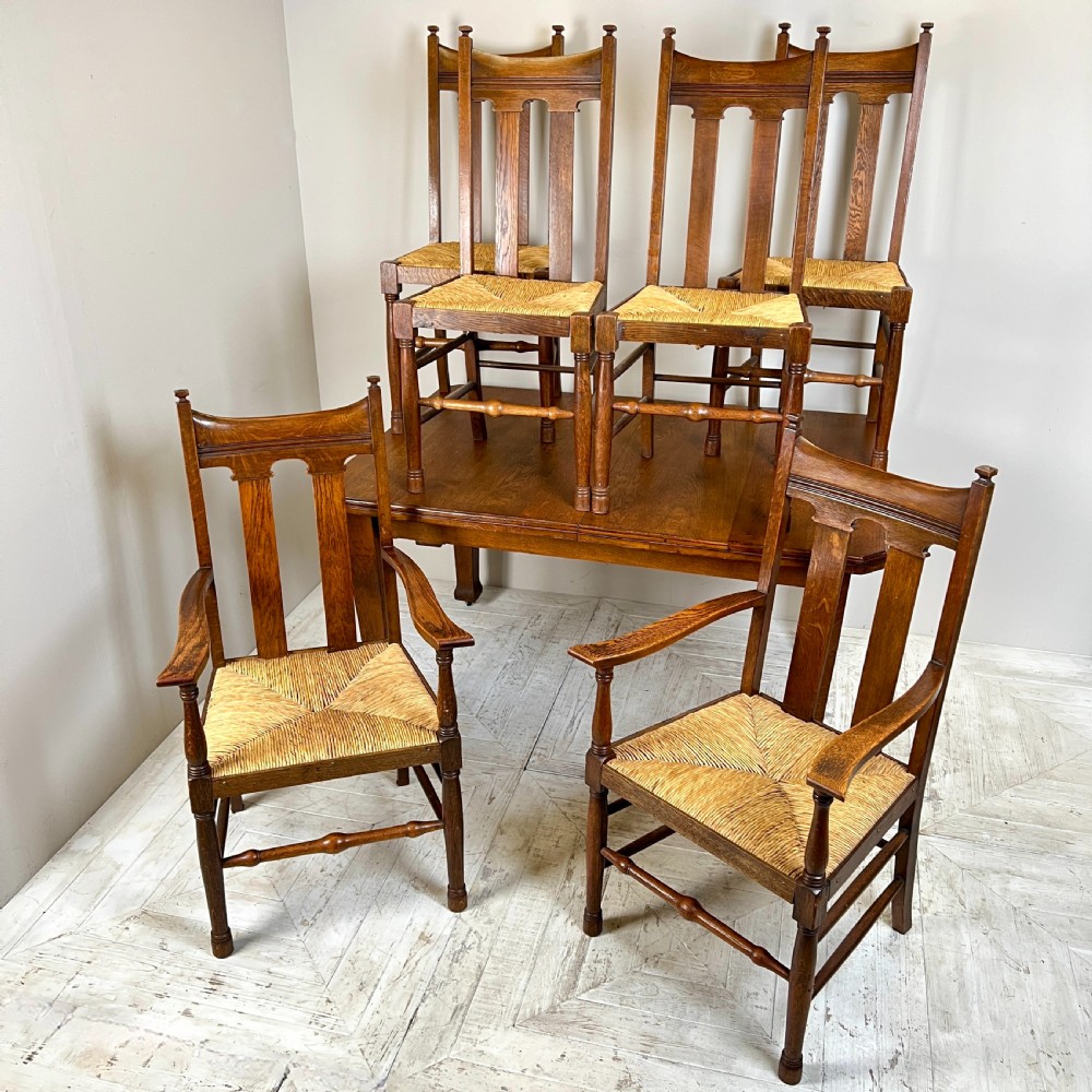 An Arts & Crafts Extending Oak Dining Table & Six Chairs