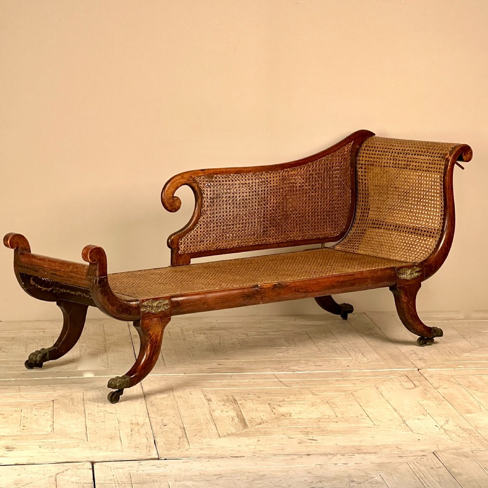 A Regency Simulated Rosewood And Cane Chaise Longue View II