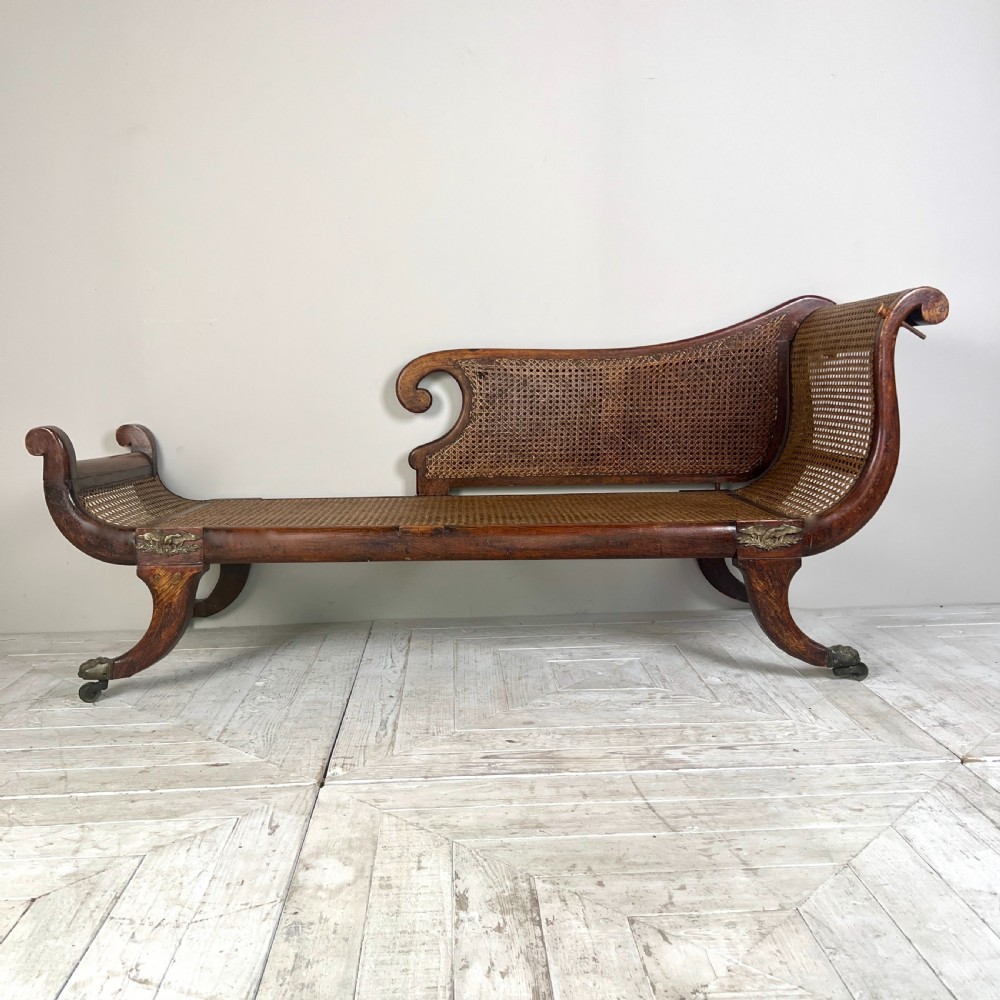 A Regency Simulated Rosewood And Cane Chaise Longue View III
