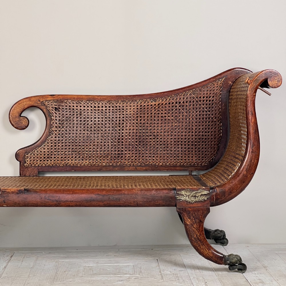 A Regency Simulated Rosewood And Cane Chaise Longue View IV