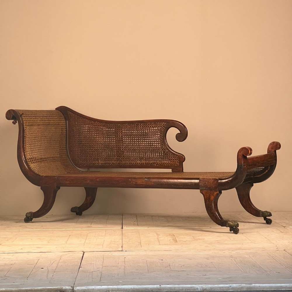 A Regency Simulated Rosewood And Cane Chaise Longue View V
