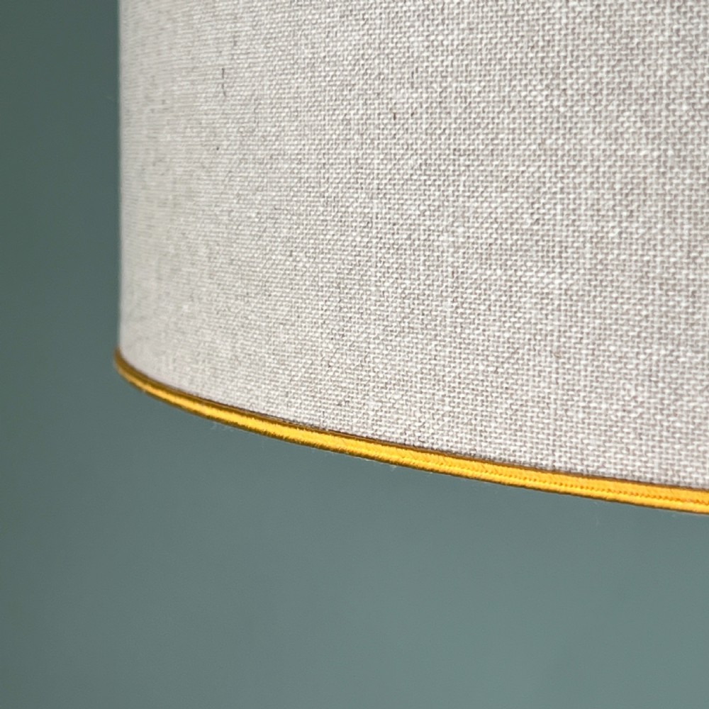 An Empire style table lamp featuring a white marble column base with gold ormolu leaf mounts and a large cream drum shade. View V