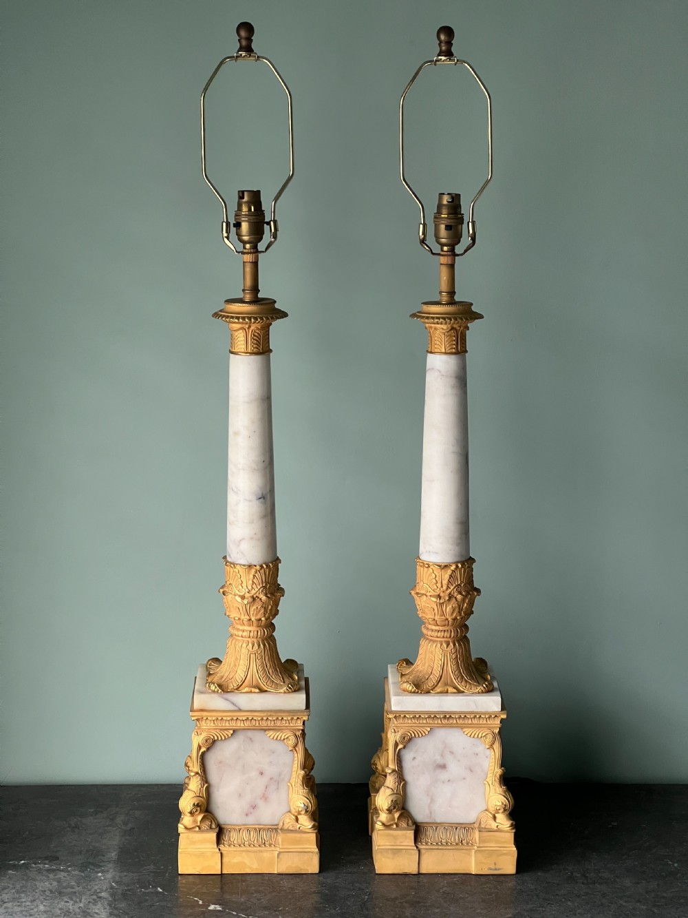 An Empire style table lamp featuring a white marble column base with gold ormolu leaf mounts and a large cream drum shade. View IX