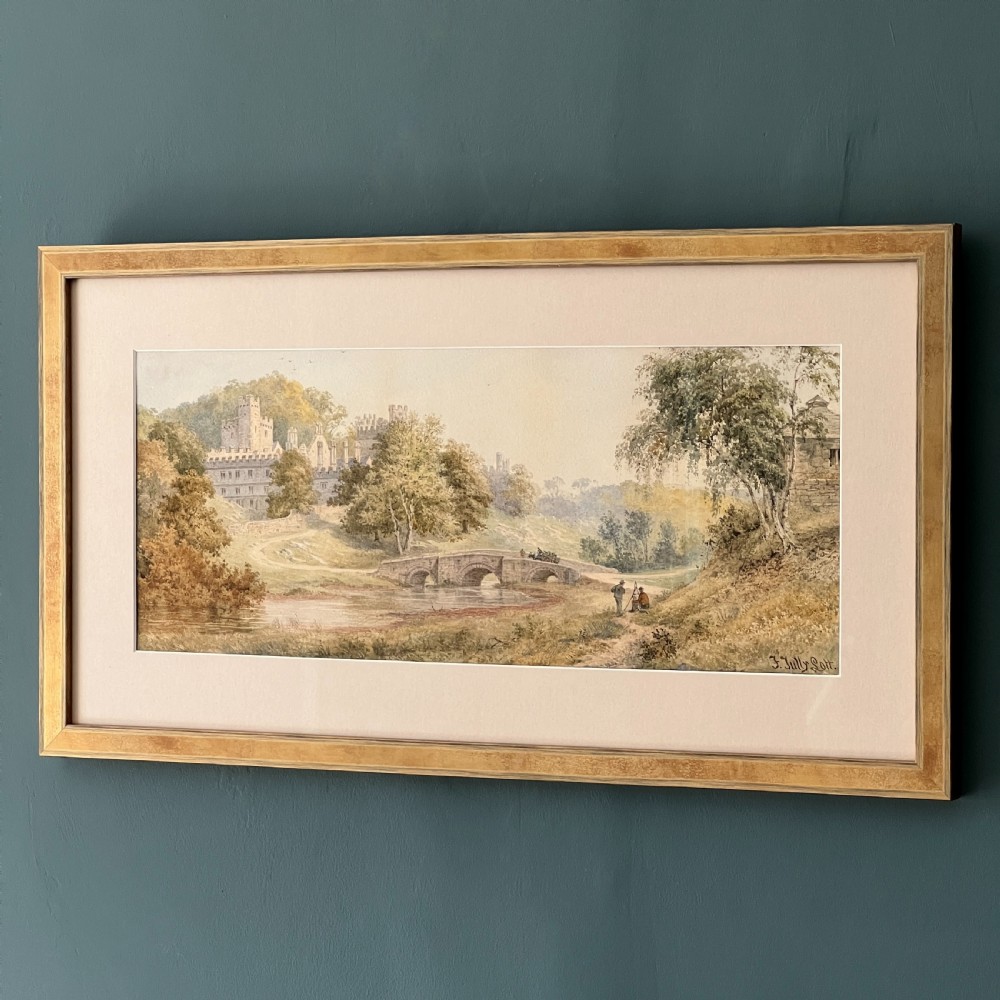 A framed Victorian watercolour painting depicting Windsor Castle beyond a river and stone bridge, framed in a gold-toned wooden frame with a cream mount. View III