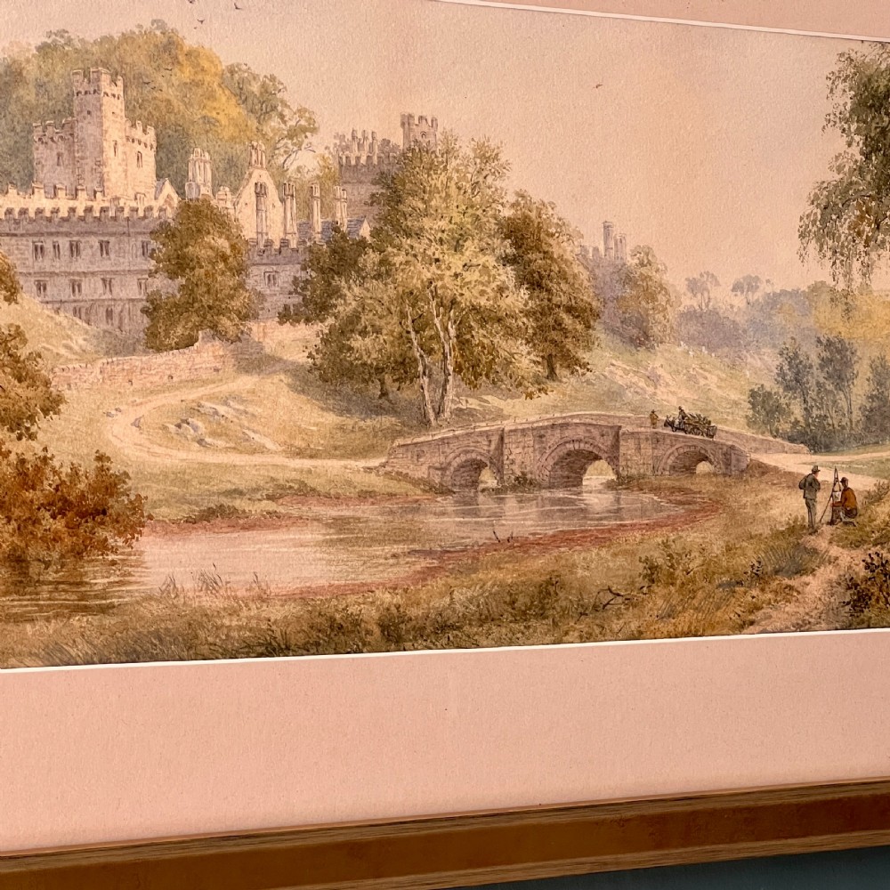 A framed Victorian watercolour painting depicting Windsor Castle beyond a river and stone bridge, framed in a gold-toned wooden frame with a cream mount. View IV
