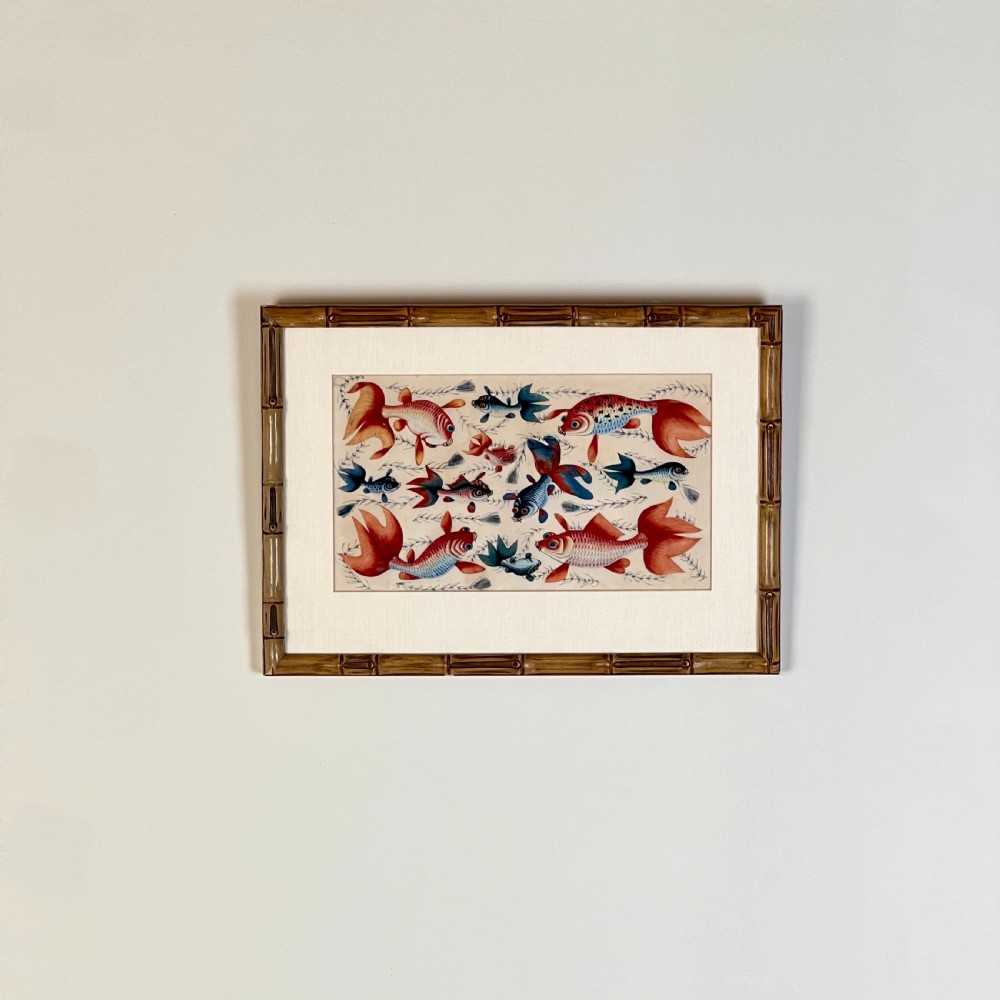 A late 19th-century Chinese gouache painting on pith paper depicting red and blue goldfish swimming among aquatic foliage, presented in a bamboo-style frame with a light mount. View II