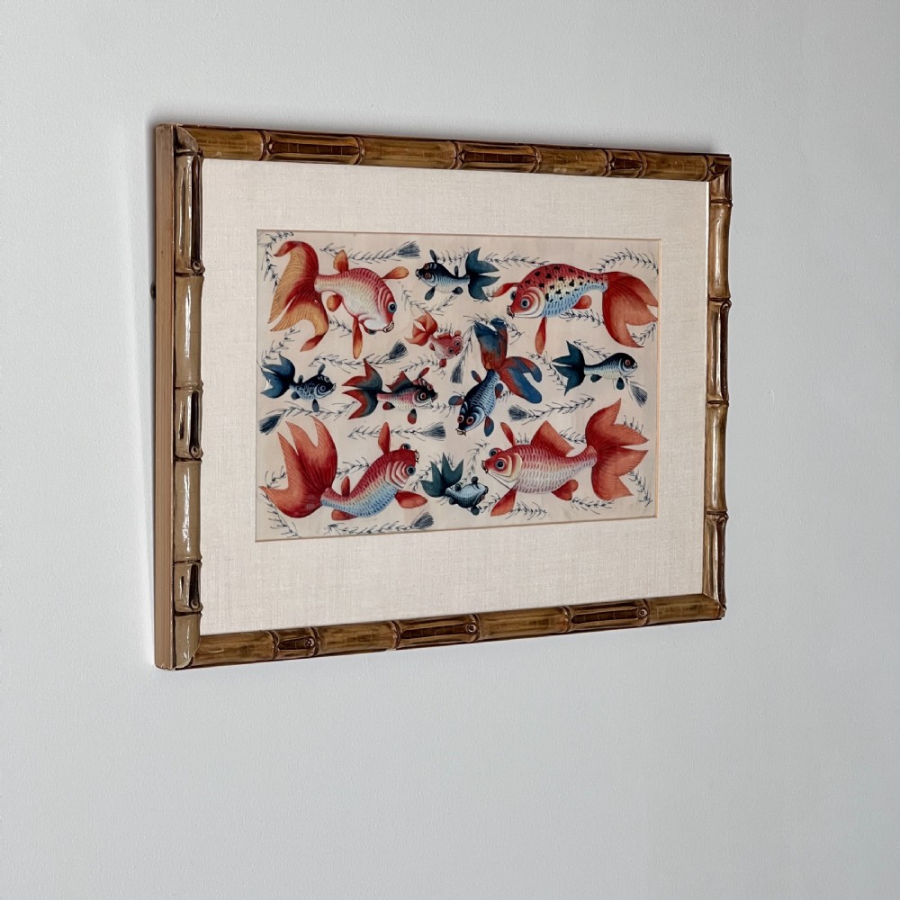 A late 19th-century Chinese gouache painting on pith paper depicting red and blue goldfish swimming among aquatic foliage, presented in a bamboo-style frame with a light mount. View III
