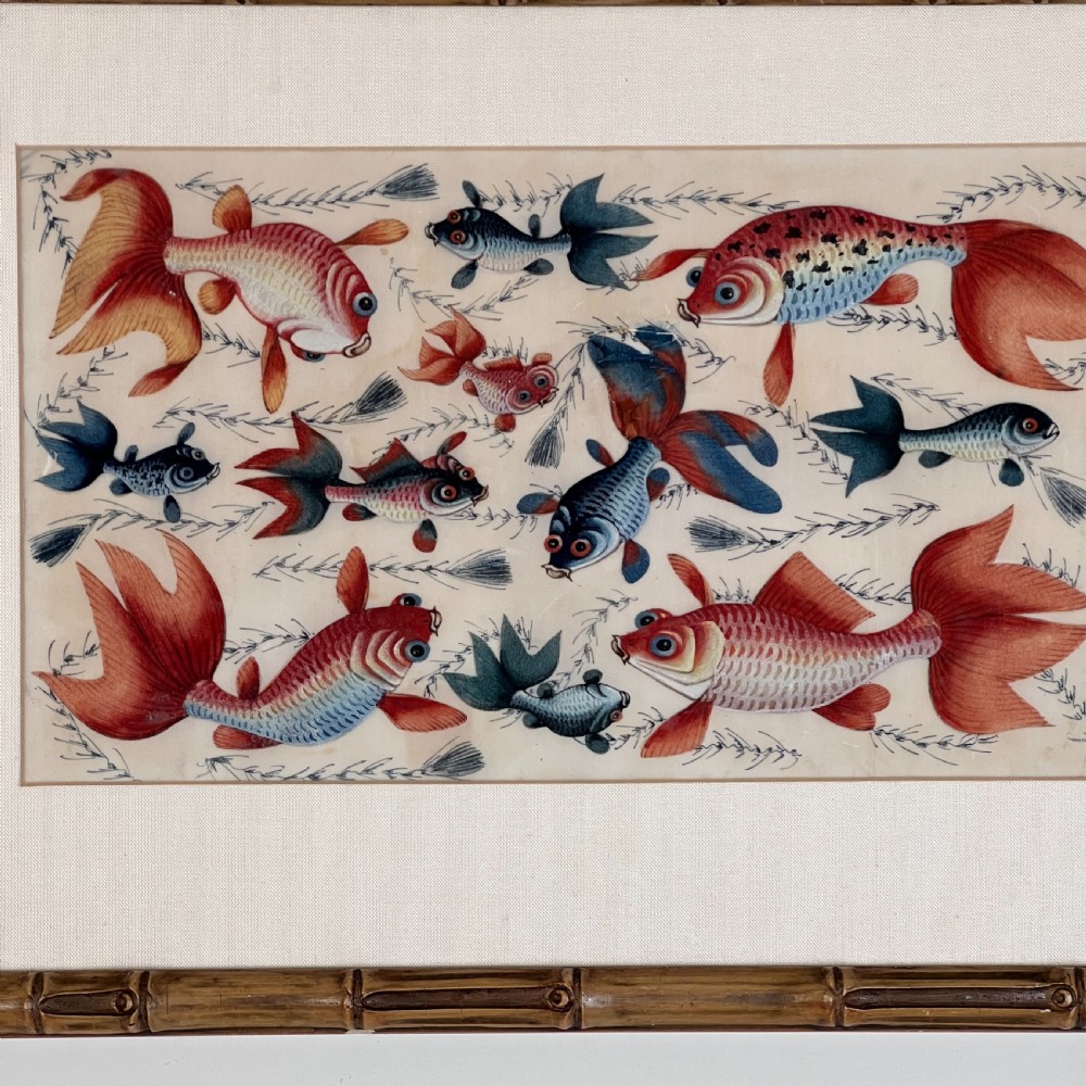 A late 19th-century Chinese gouache painting on pith paper depicting red and blue goldfish swimming among aquatic foliage, presented in a bamboo-style frame with a light mount. View V