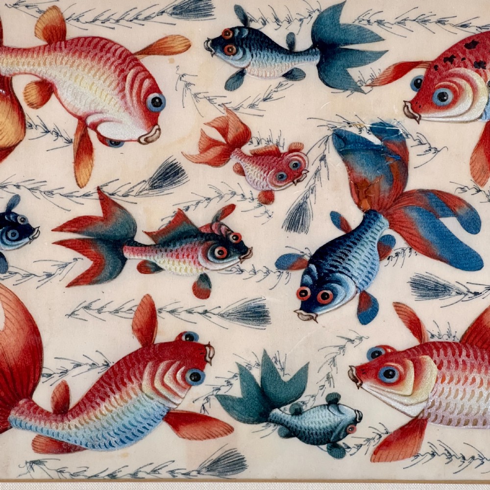 A late 19th-century Chinese gouache painting on pith paper depicting red and blue goldfish swimming among aquatic foliage, presented in a bamboo-style frame with a light mount. View VI