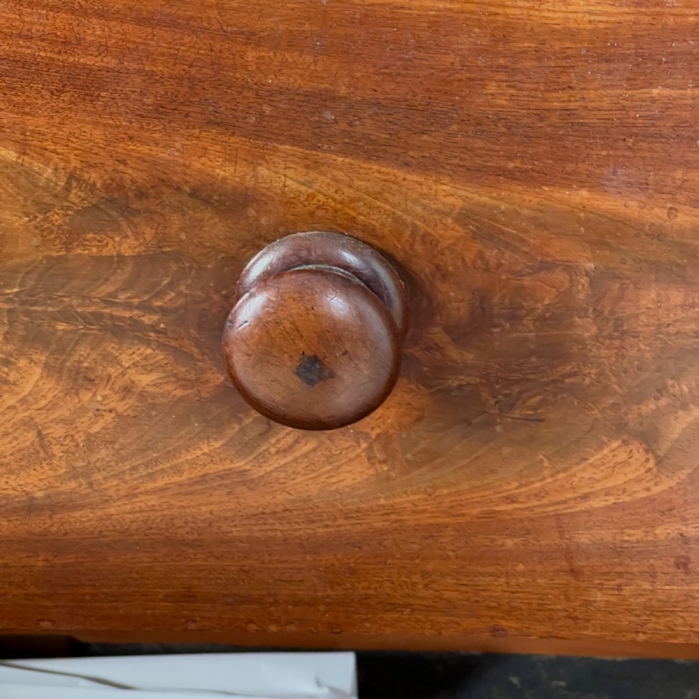 A Victorian flame mahogany breakfront wardrobe featuring a central four-drawer chest flanked by two tall arched cupboards on a plinth base. View VII