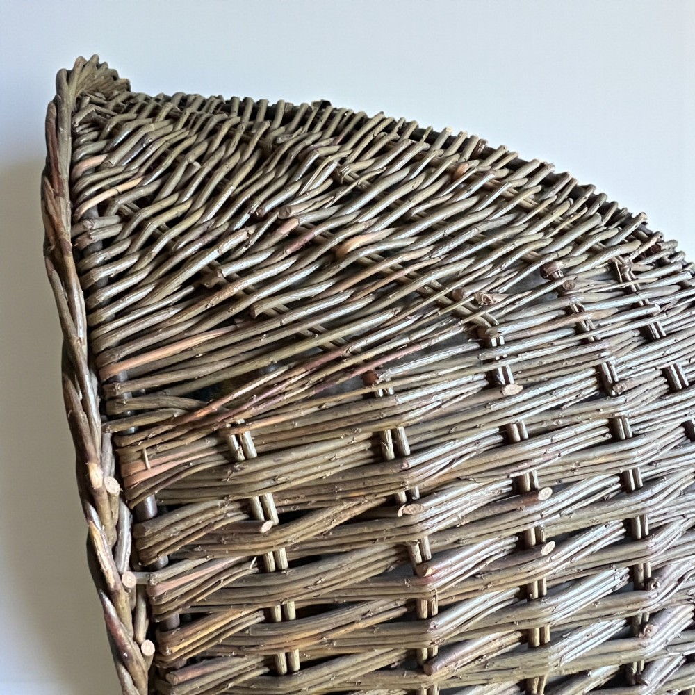A high-backed woven wicker porters chair featuring a hooded canopy and floral upholstered linen interior. View VIII