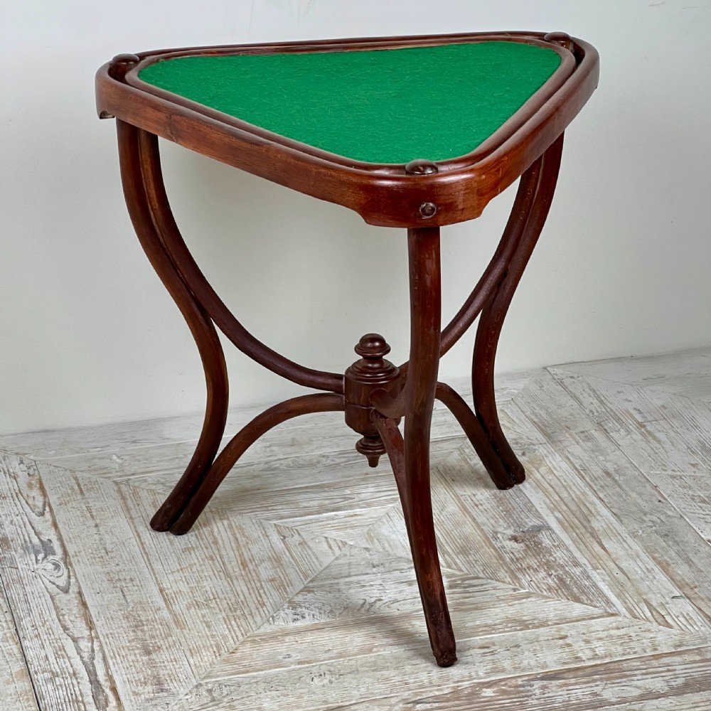 A triangular bentwood card table featuring a green felt playing surface, three curved legs, and a central turned wooden finial. View II