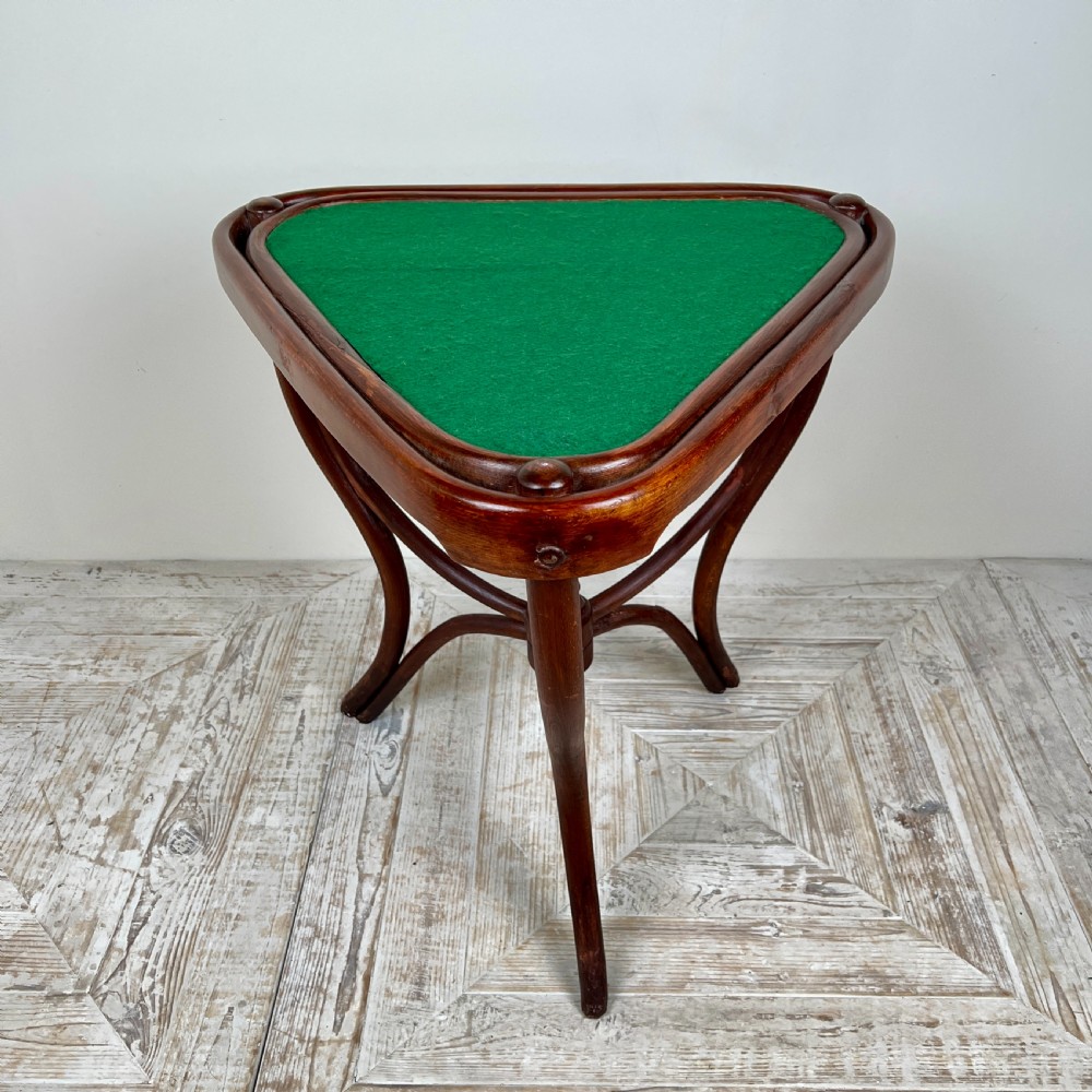 A triangular bentwood card table featuring a green felt playing surface, three curved legs, and a central turned wooden finial. View V