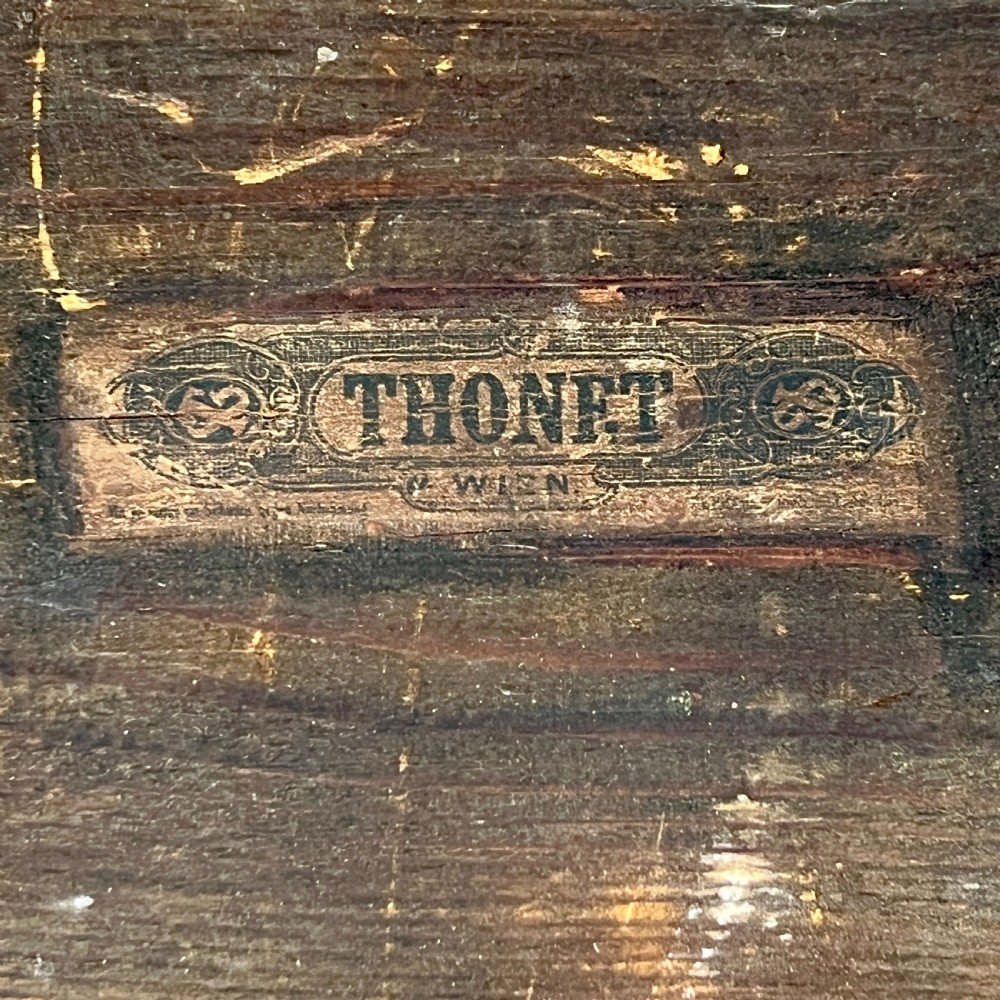 A triangular bentwood card table featuring a green felt playing surface, three curved legs, and a central turned wooden finial. View IX