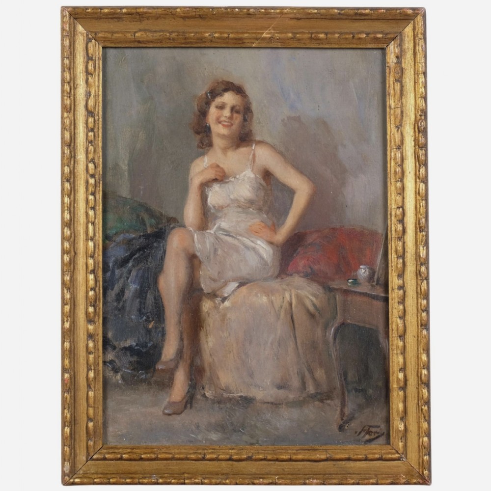 An oil painting depicting a seated woman in a light dress contained within an ornate gilt wooden frame.