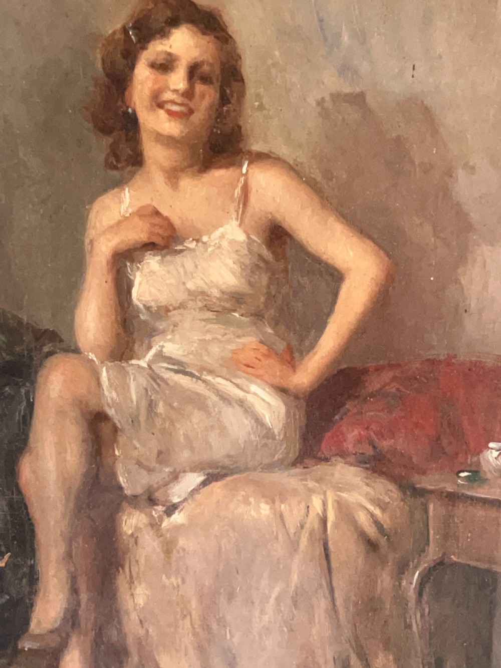 An oil painting depicting a seated woman in a light dress contained within an ornate gilt wooden frame. View IV