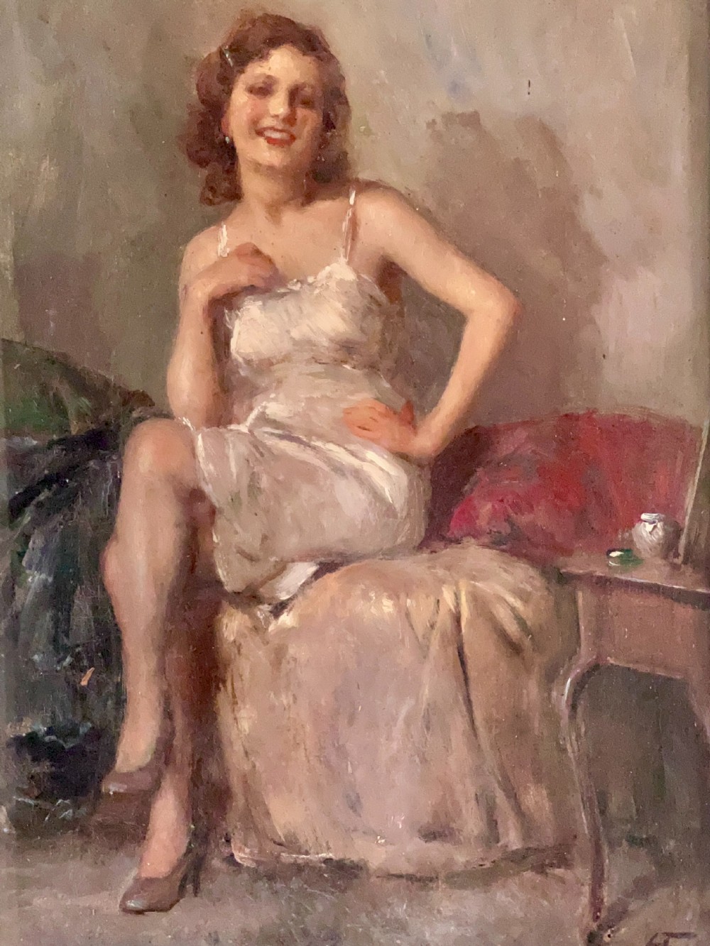 An oil painting depicting a seated woman in a light dress contained within an ornate gilt wooden frame. View VI