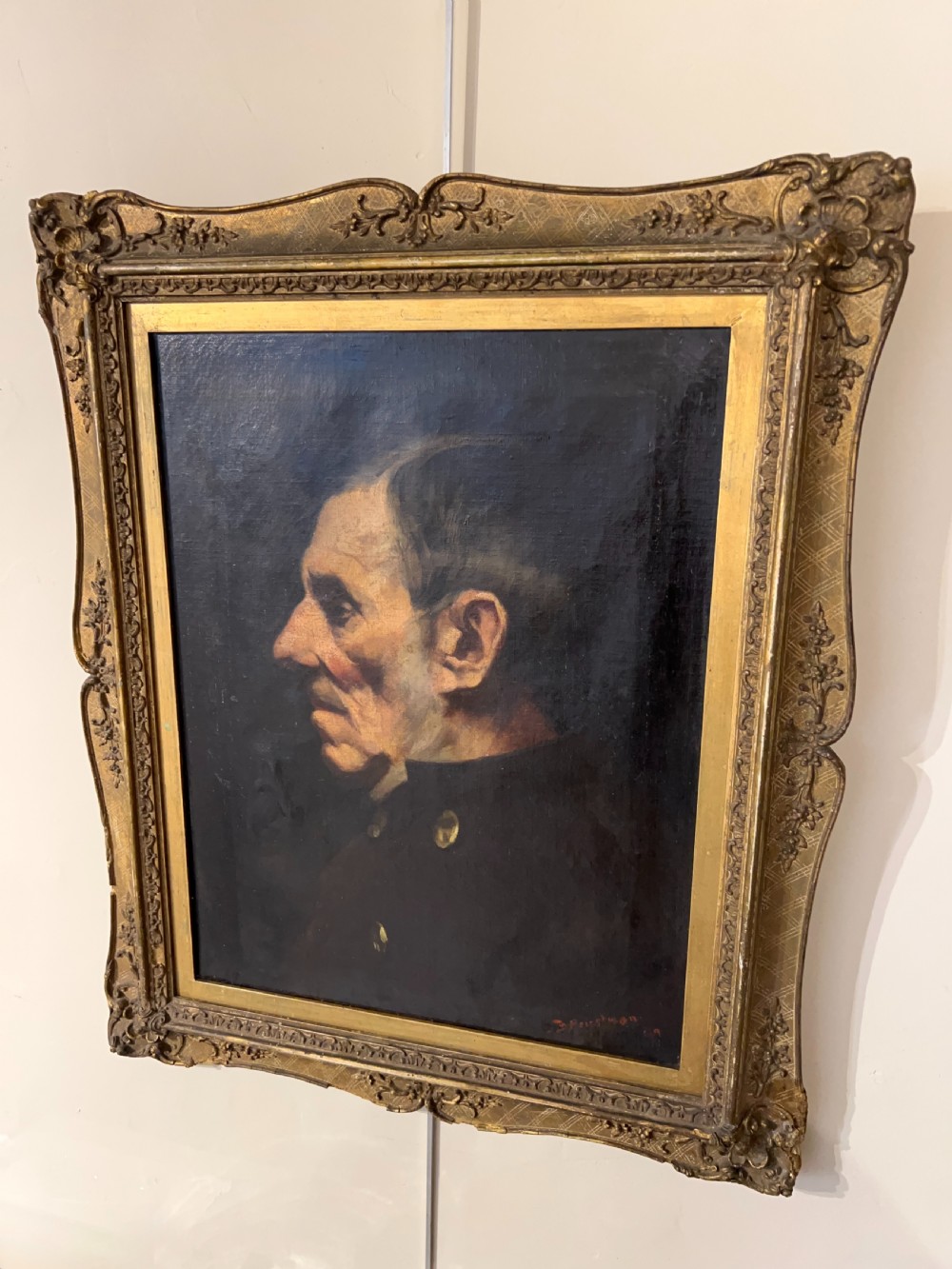 A side-profile oil portrait painting of a gentleman set within an ornate carved gilded wooden frame. View II