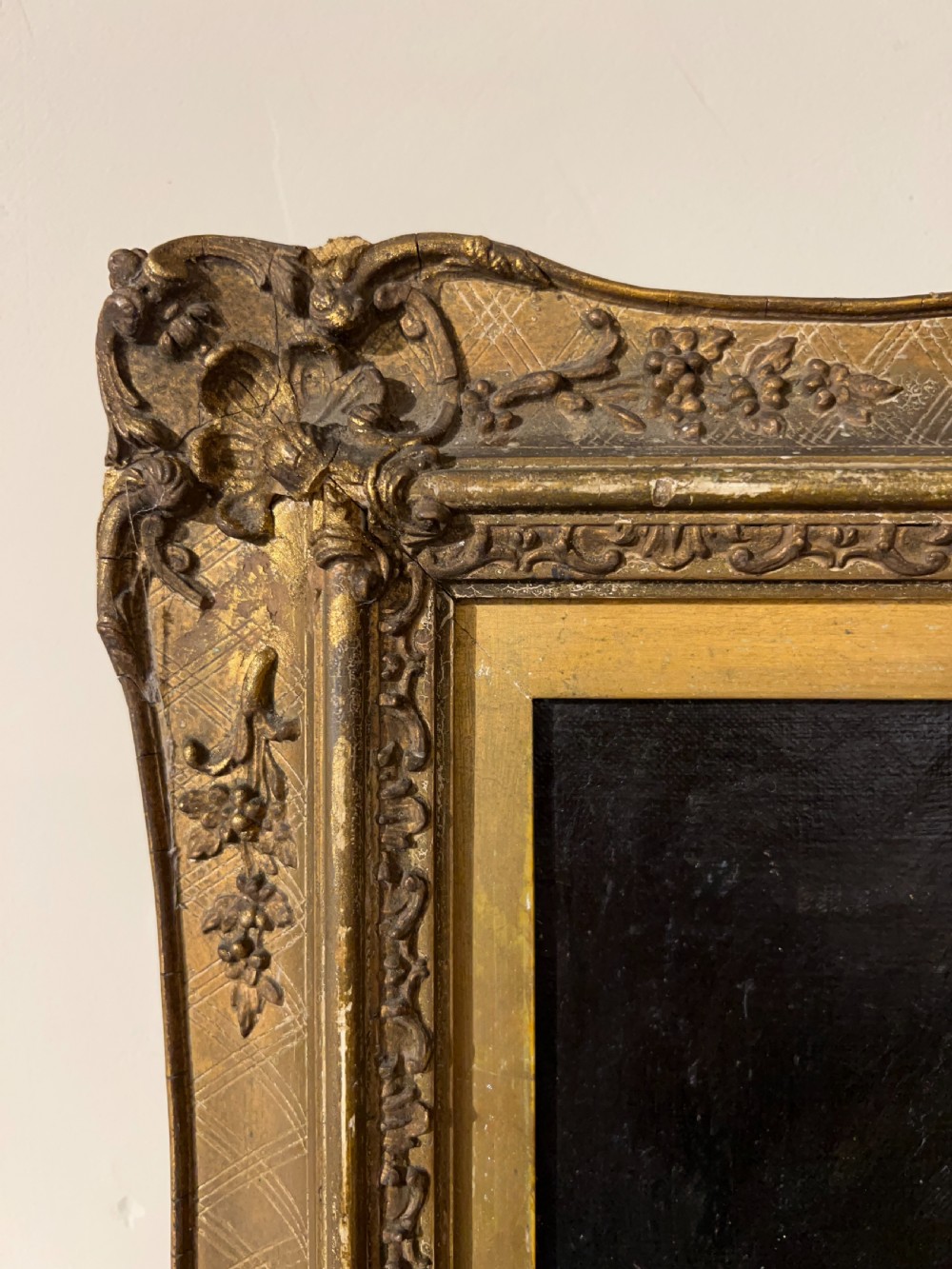 A side-profile oil portrait painting of a gentleman set within an ornate carved gilded wooden frame. View VII