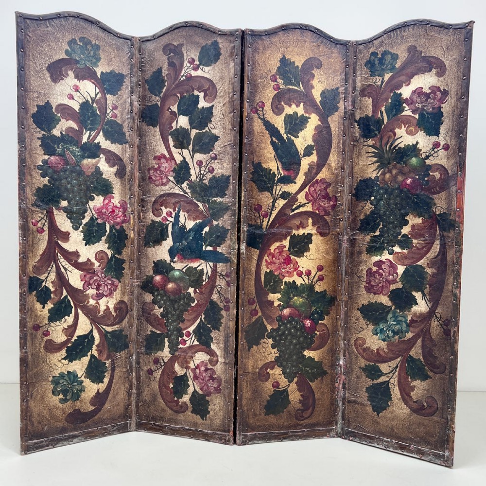 A four-panel French room divider screen made of gilt leather hand-painted with green foliage, floral scrolls, and birds, bordered with brass studding. View II