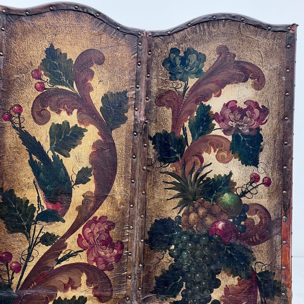 A four-panel French room divider screen made of gilt leather hand-painted with green foliage, floral scrolls, and birds, bordered with brass studding. View VI