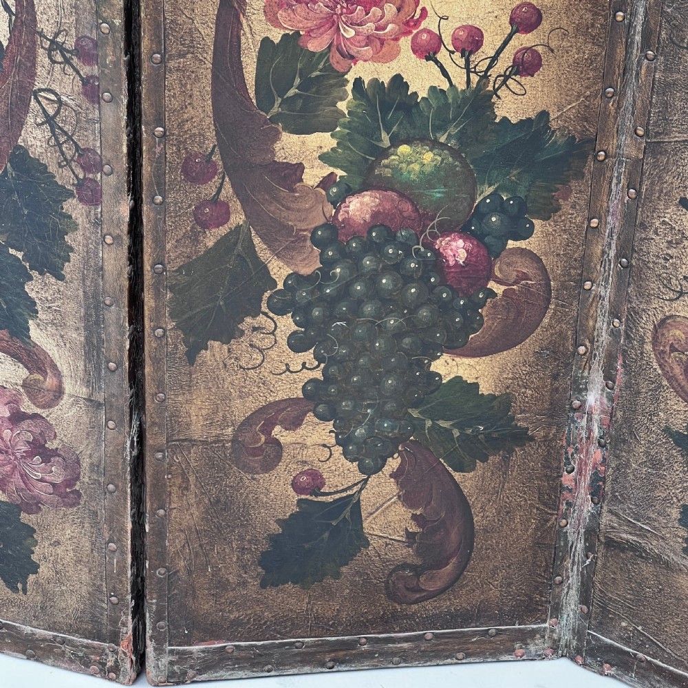 A four-panel French room divider screen made of gilt leather hand-painted with green foliage, floral scrolls, and birds, bordered with brass studding. View VIII