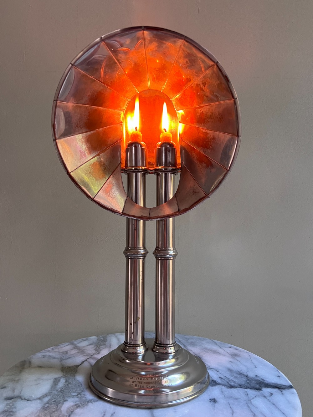An Edwardian silver-plated candle lamp featuring twin column stems, a curved segmented reflector hood, and an engraved circular base. View III