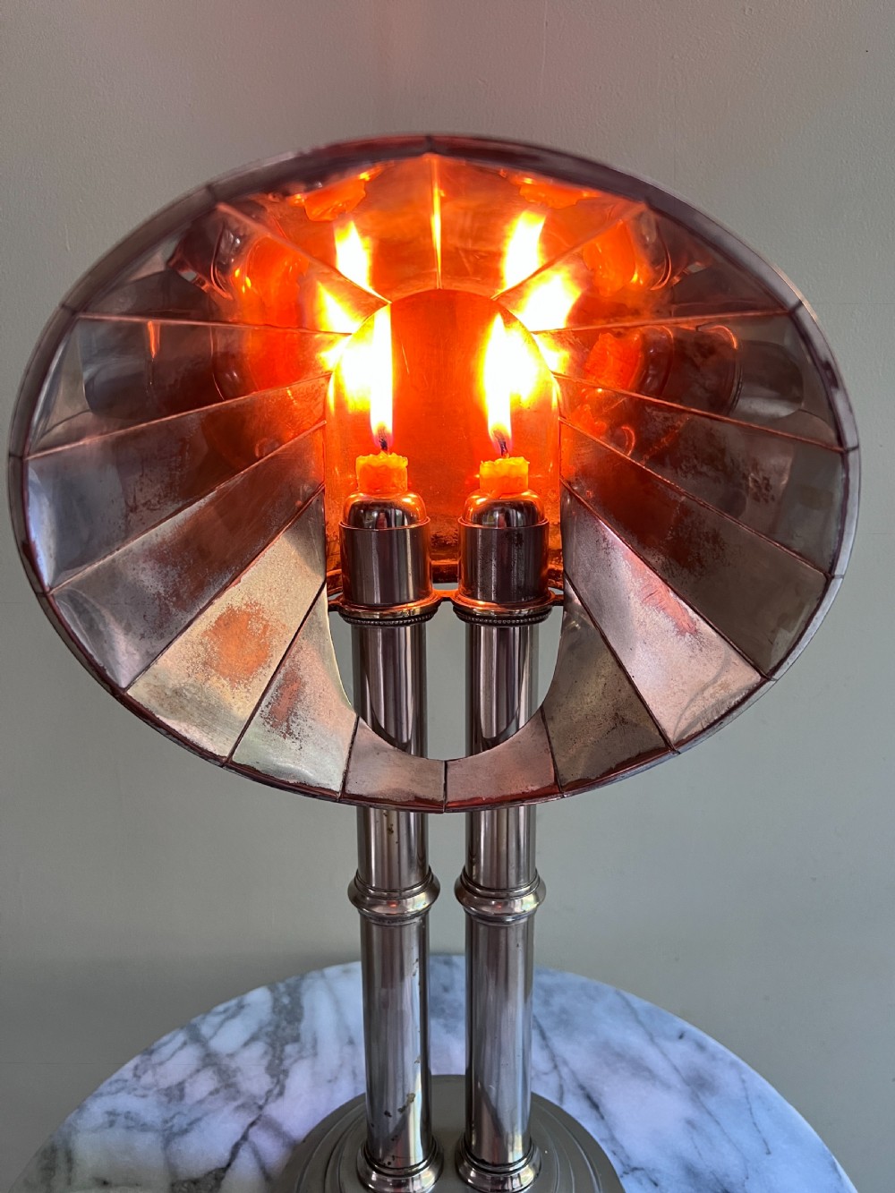 An Edwardian silver-plated candle lamp featuring twin column stems, a curved segmented reflector hood, and an engraved circular base. View IV