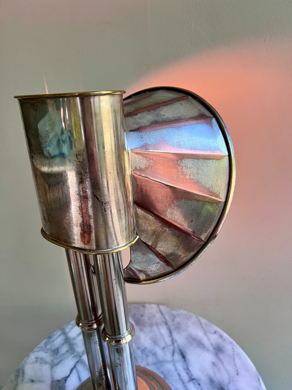 An Edwardian silver-plated candle lamp featuring twin column stems, a curved segmented reflector hood, and an engraved circular base. View VI