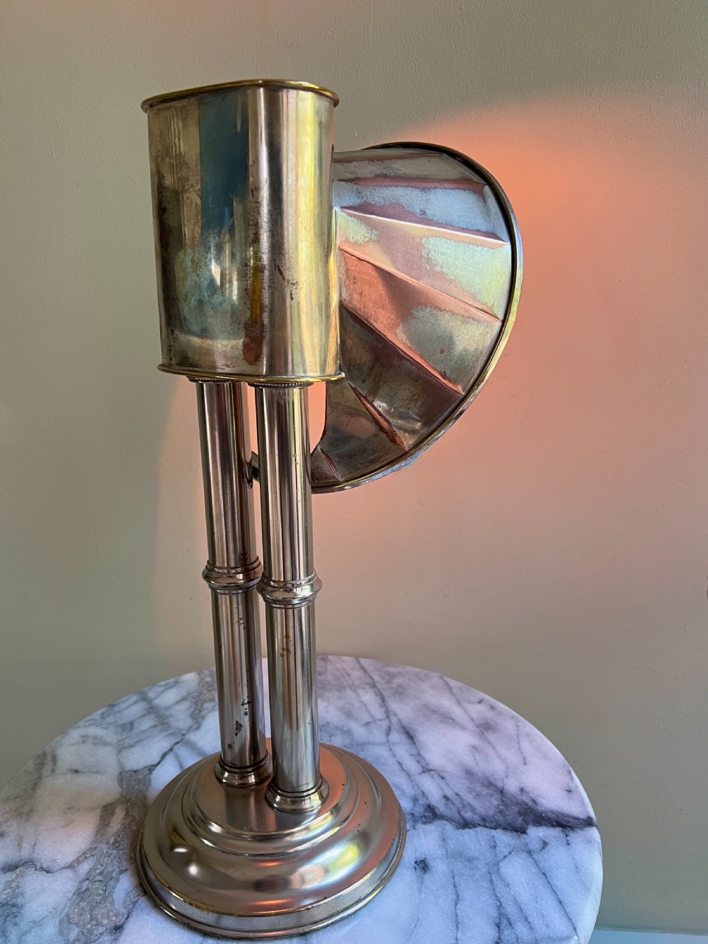 An Edwardian silver-plated candle lamp featuring twin column stems, a curved segmented reflector hood, and an engraved circular base. View VII