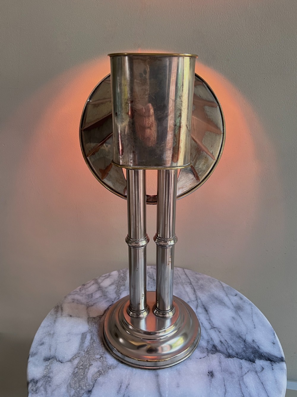 An Edwardian silver-plated candle lamp featuring twin column stems, a curved segmented reflector hood, and an engraved circular base. View VIII