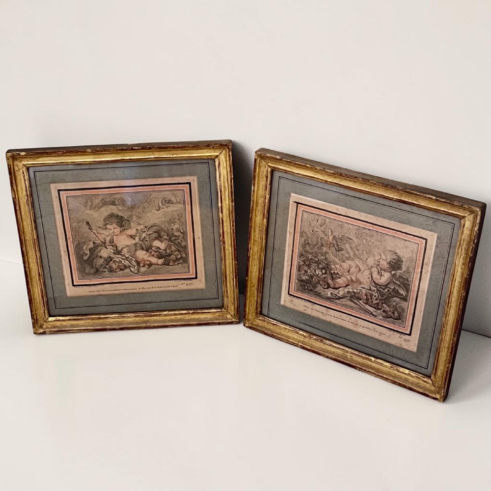 A pair of 18th-century French engravings depicting classical cherubs, mounted and framed in rectangular giltwood frames.