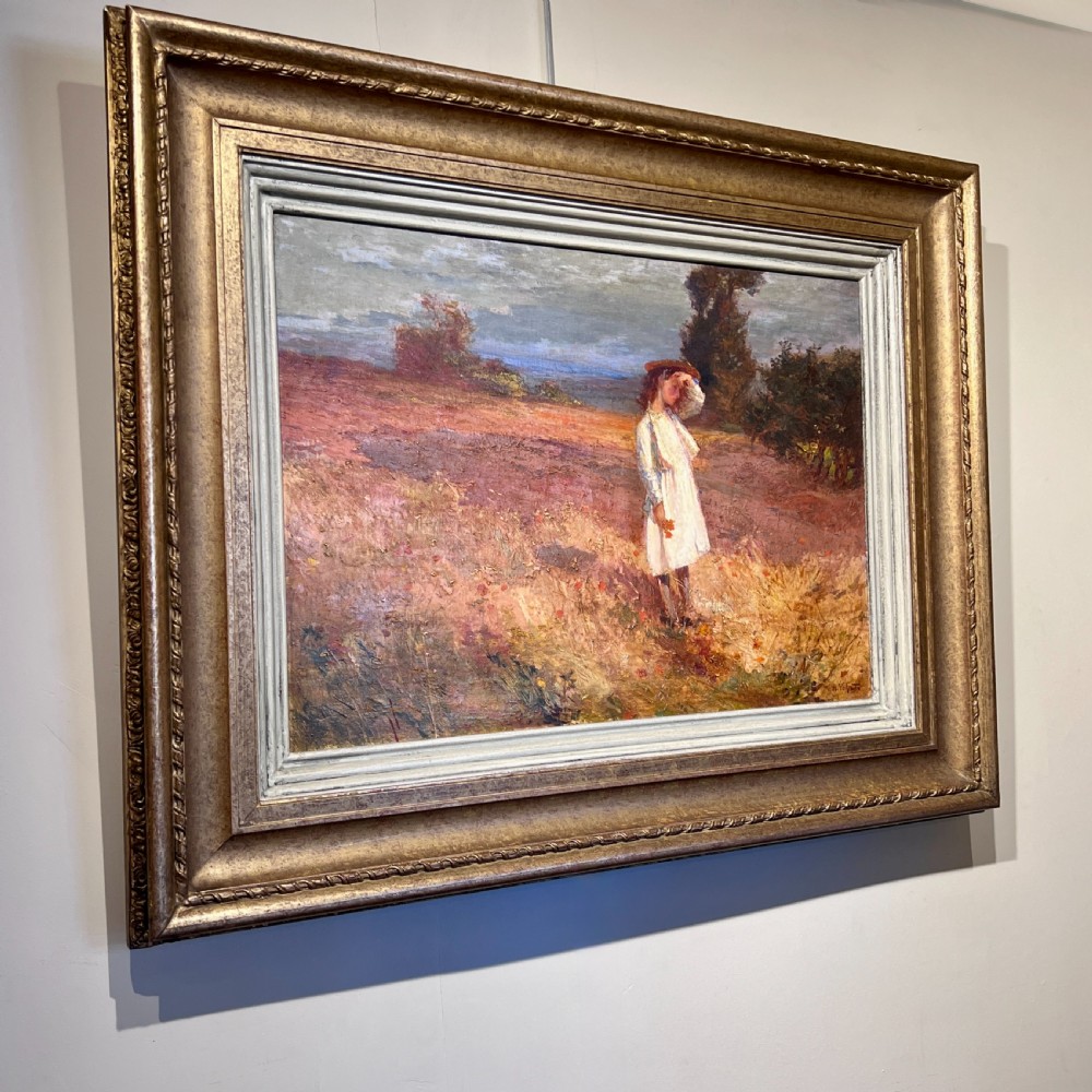 An impressionist oil painting depicting a young figure in a white dress standing in a sunlit field, presented in a moulded gilt frame. View II