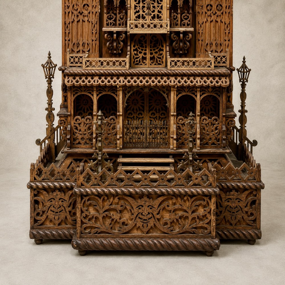 A carved wooden clock case designed in a Gothic cathedral architectural style with detailed fretwork, three spires, and a circular central opening. View VII