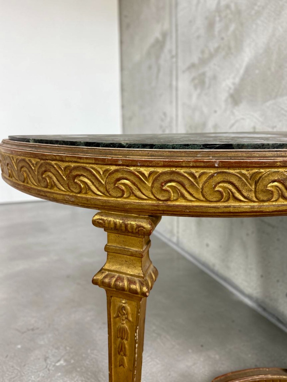A pair of 19th-century Louis XVI Revival demilune console tables with carved gold giltwood frames and dark green marble tops. View IV