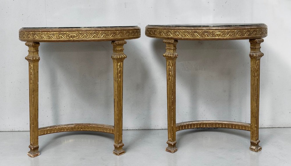 A pair of 19th-century Louis XVI Revival demilune console tables with carved gold giltwood frames and dark green marble tops. View VI