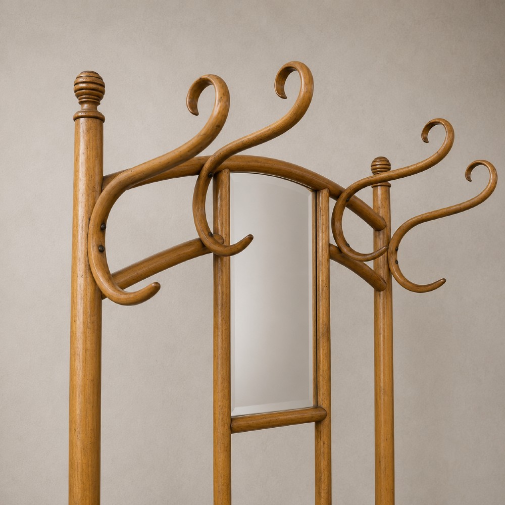 A tall steam-bent beechwood hall stand with a warm honey finish, featuring top coat hooks, a central rectangular mirror, a small drawer, and a lower umbrella rail. View IV