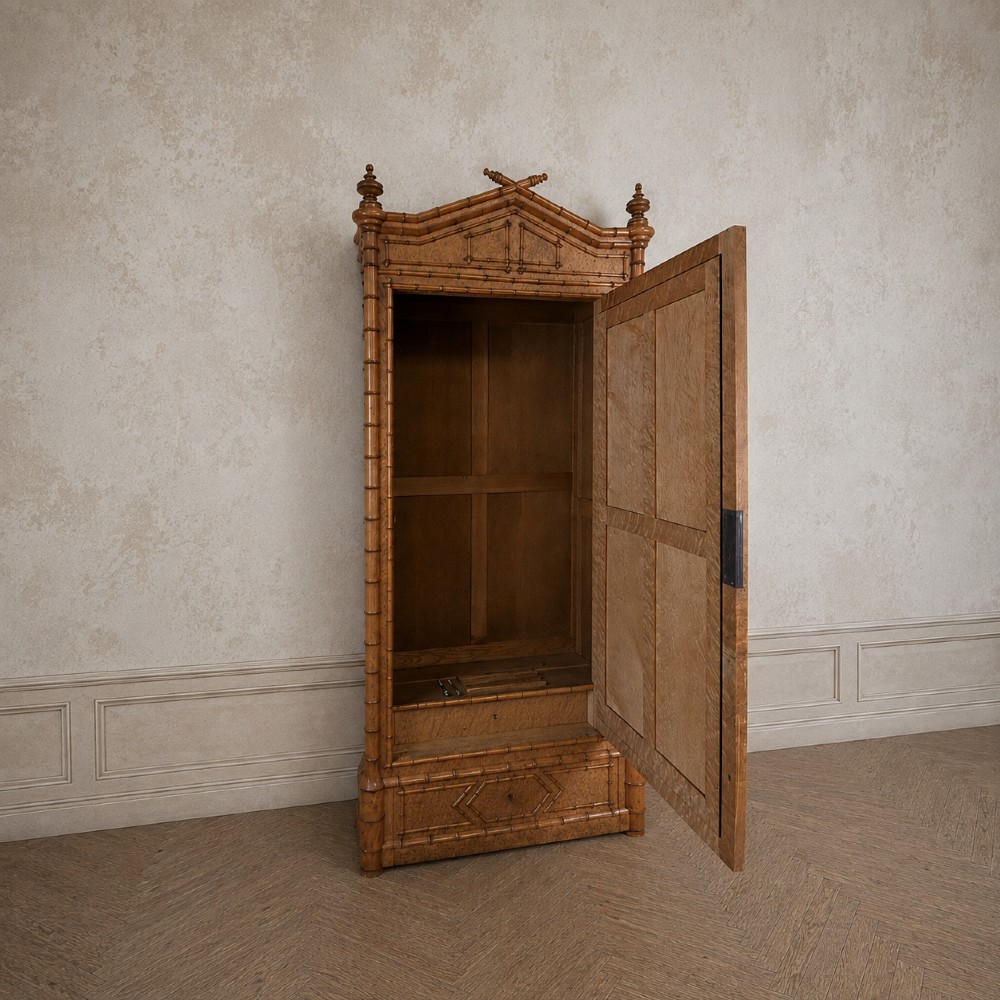 French birds eye maple single door armoire featuring faux bamboo turned mouldings, a full-length mirrored panel, base drawer, and carved cresting. View III