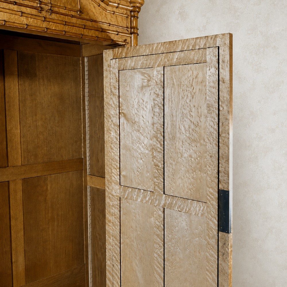 French birds eye maple single door armoire featuring faux bamboo turned mouldings, a full-length mirrored panel, base drawer, and carved cresting. View IV