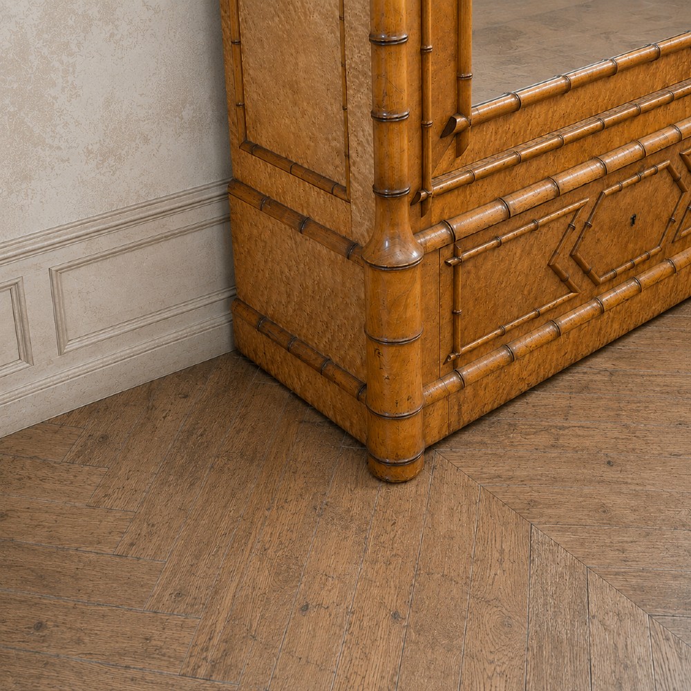 French birds eye maple single door armoire featuring faux bamboo turned mouldings, a full-length mirrored panel, base drawer, and carved cresting. View VI