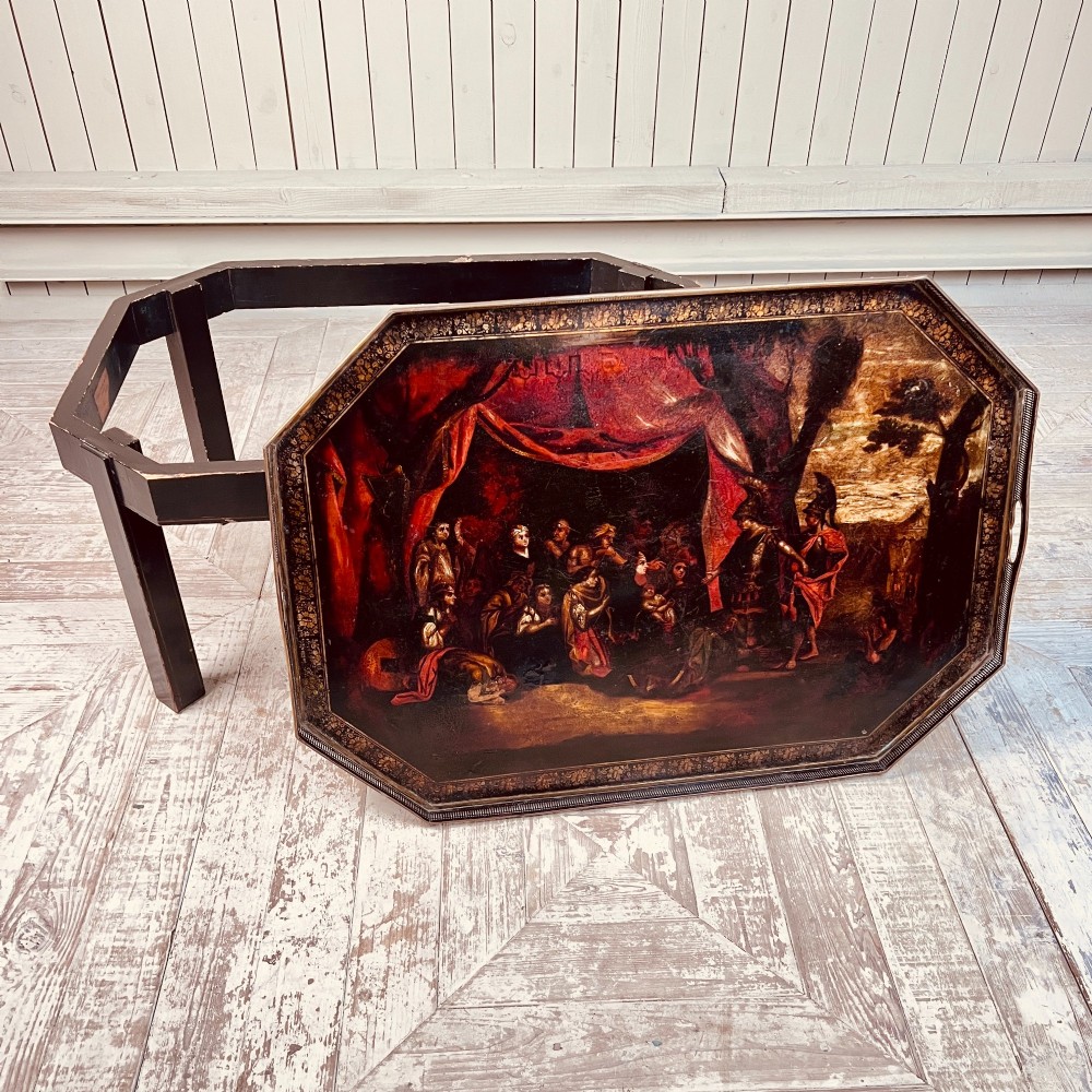 A nineteenth-century octagonal painted metal toleware tray table featuring a classical scene depicting the family of Darius before Alexander, set upon a dark wooden base. View IV