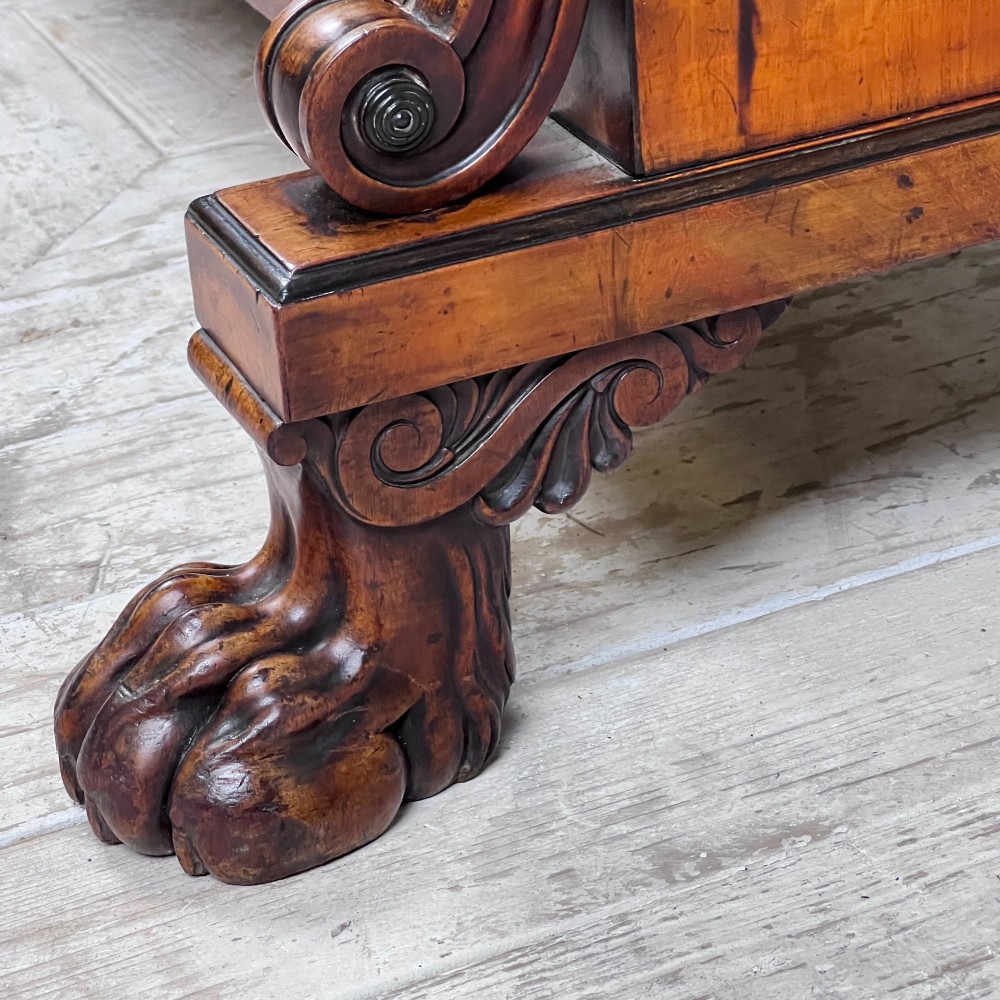 A Regency mahogany low chiffonier bookcase featuring brass wire grille doors, carved scroll supports terminating in paw feet, and brass inlay. View VIII