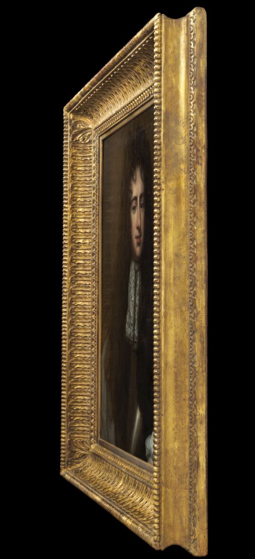 fig 4. An oil portrait depicting a gentleman in a long dark wig, lace cravat, and blue cloak, presented within an ornate carved giltwood frame.