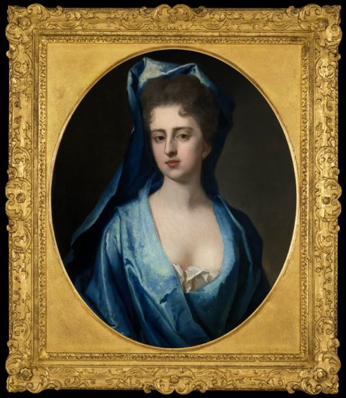 fig 2. A pair of 18th-century oil portrait paintings depicting a man and a woman in blue drapery, set within oval openings inside heavily carved gold gilt frames.