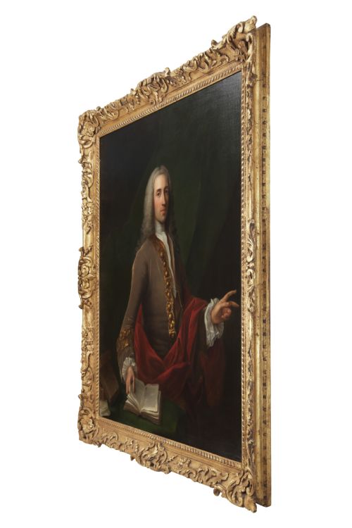 fig 1. An 18th-century oil portrait depicting a wigged gentleman in a brown coat seated beside open books, enclosed in a carved giltwood frame.
