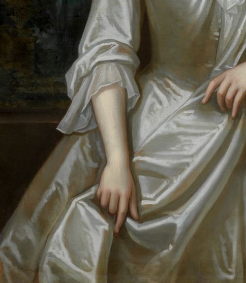 fig 8. A portrait depicting a woman in a silver satin dress seated next to draped red fabric, enclosed within an ornate carved gold frame.