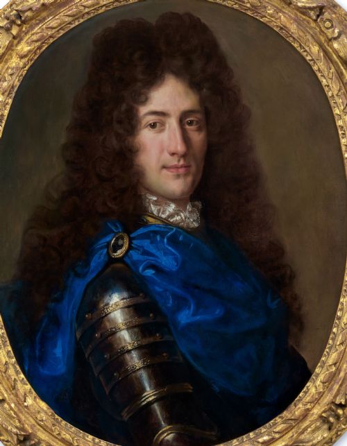 fig 2. An oval Baroque oil painting depicting a long-haired gentleman in plate armour with a bright blue cloak, presented within an ornate carved giltwood frame.